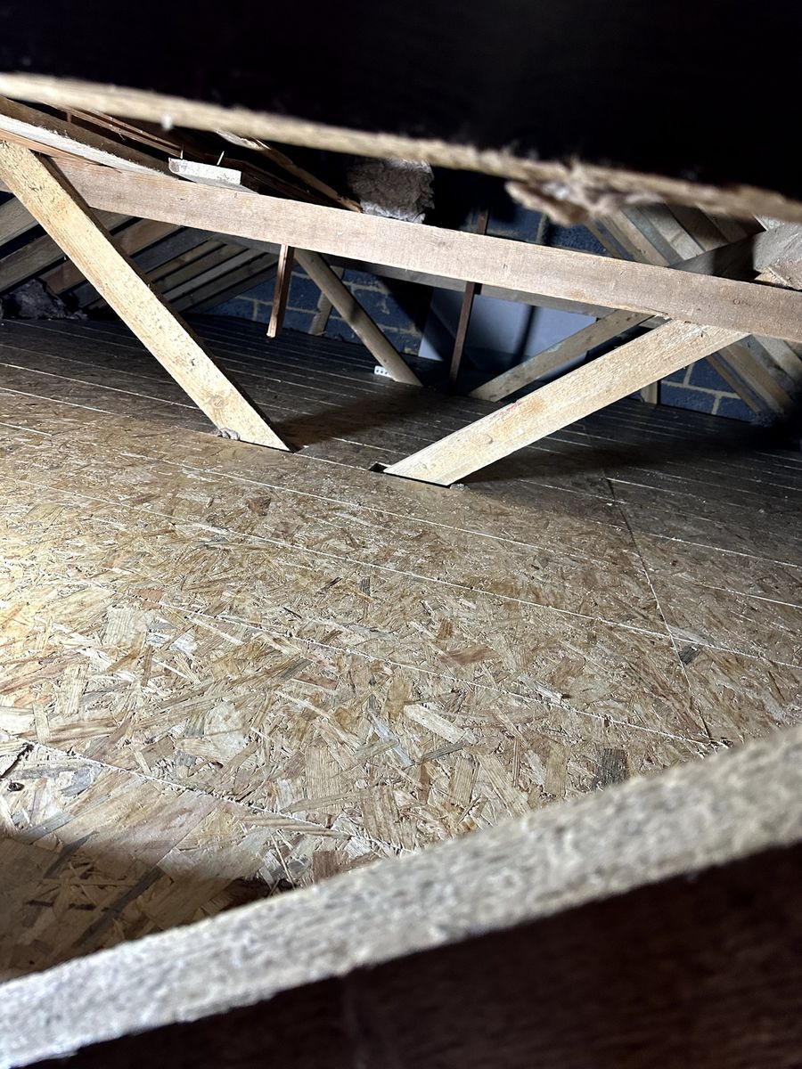 OSB loft boarding laid across an older loft, seen through the loft hatch